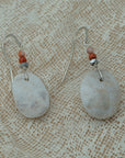 Handmade earrings with smooth white pebbles, accented with agate and hematite beads on silver hooks.