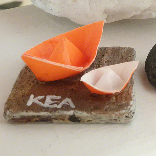 pebble with a paper boat