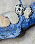 decorative wreath with seashells and pebbles