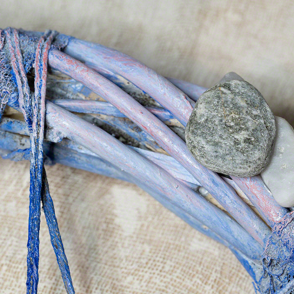 decorative wreath with seashells and pebbles