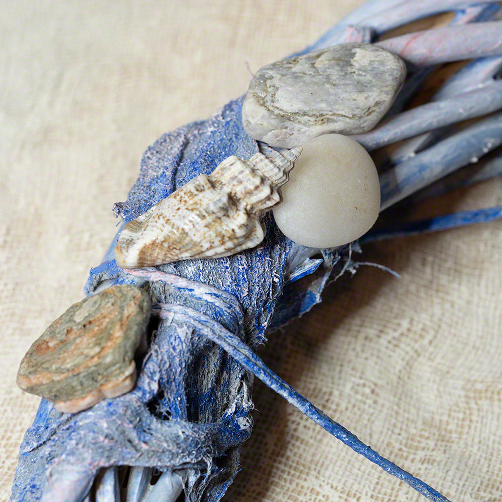 decorative wreath with seashells and pebbles