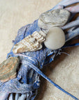 decorative wreath with seashells and pebbles