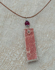 Clay pendant in red iridescent shades