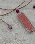 Clay pendant in red iridescent shades