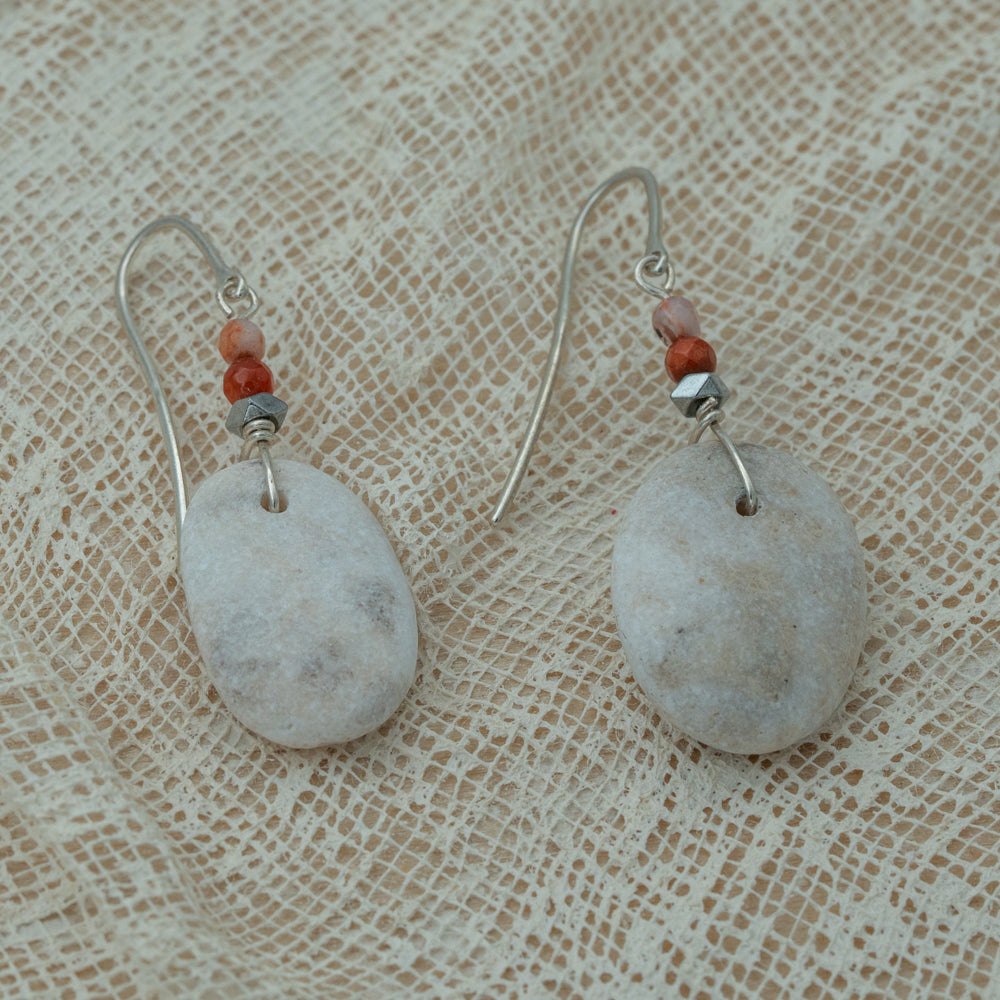 Handmade earrings with smooth white pebbles, accented with agate and hematite beads on silver hooks.