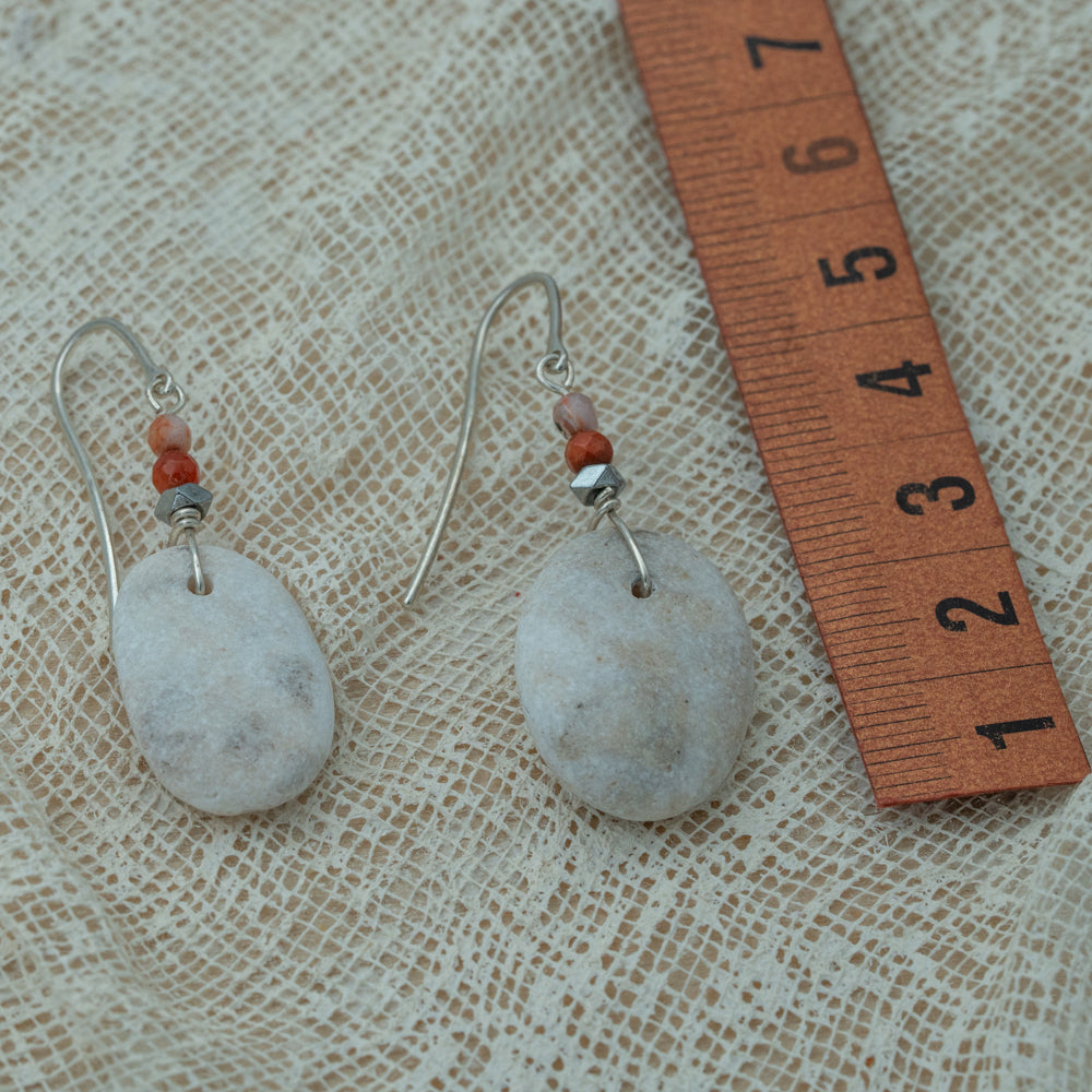 Handmade earrings with smooth white pebbles, accented with agate and hematite beads on silver hooks.