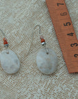 Handmade earrings with smooth white pebbles, accented with agate and hematite beads on silver hooks.