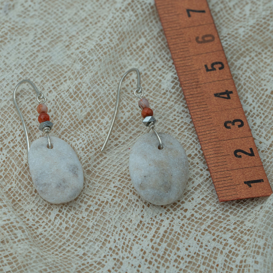 Handmade earrings with smooth white pebbles, accented with agate and hematite beads on silver hooks.