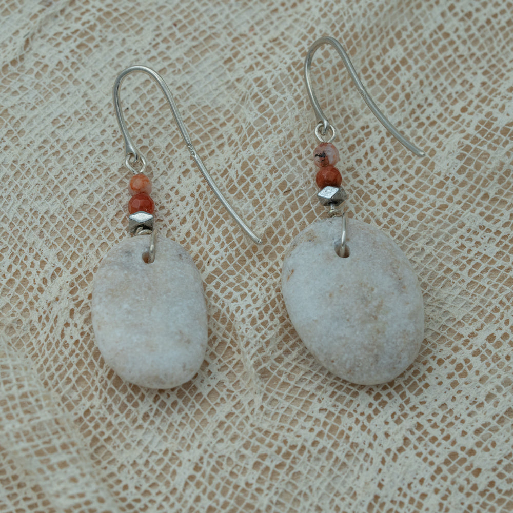 Handmade earrings with smooth white pebbles, accented with agate and hematite beads on silver hooks.