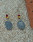 Handmade earrings with smooth gray pebbles, accented with red and yellow agate beads on silver hooks.