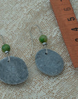 Handmade earrings with smooth round pebbles, accented with green agate and hematite beads on silver hooks.