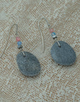 Handmade earrings with smooth gray pebbles, accented with pink agate and hematite beads on silver hooks