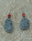 Handmade earrings with smooth gray pebbles, accented with red agate and hematite beads on silver hooks.