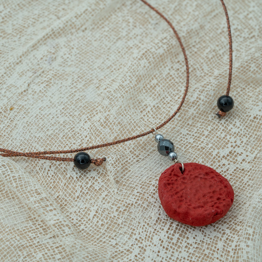 Handmade red clay pendant with hematite