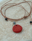 Handmade red clay pendant with hematite