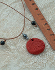 Handmade red clay pendant with hematite