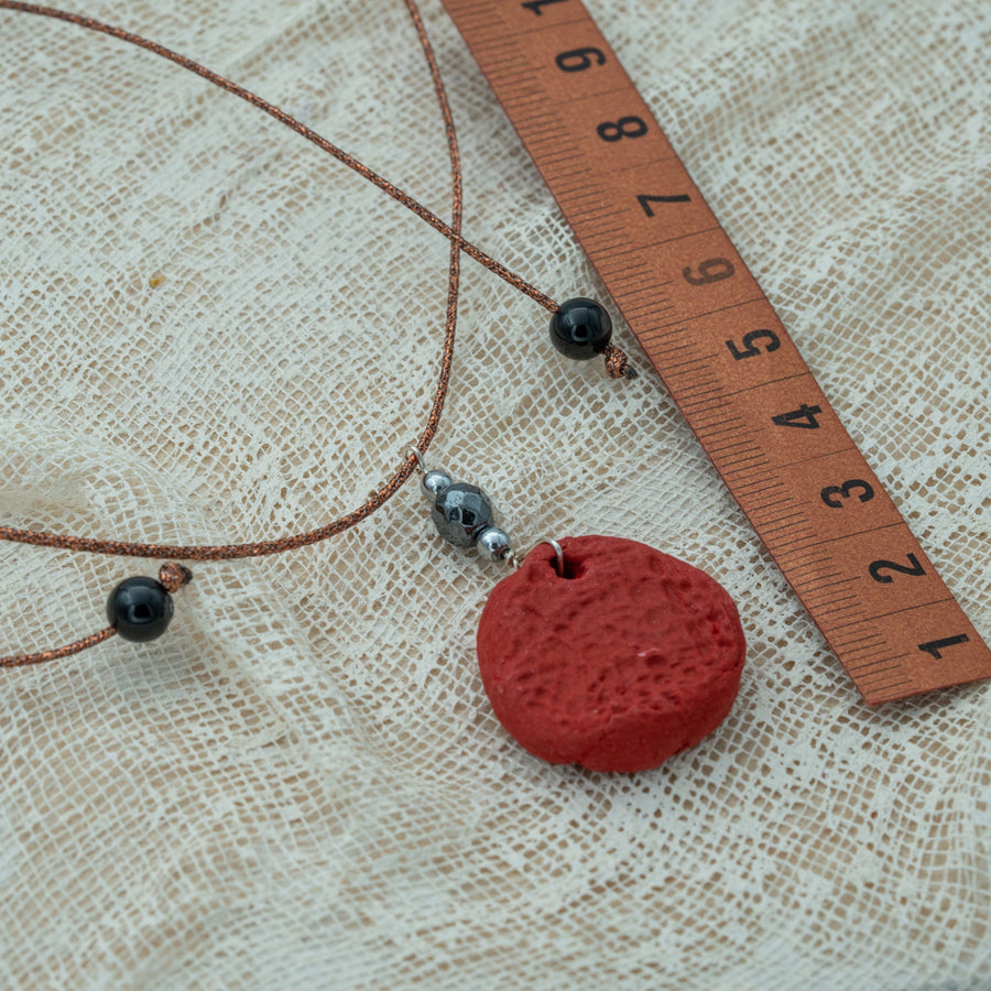 Handmade red clay pendant with hematite