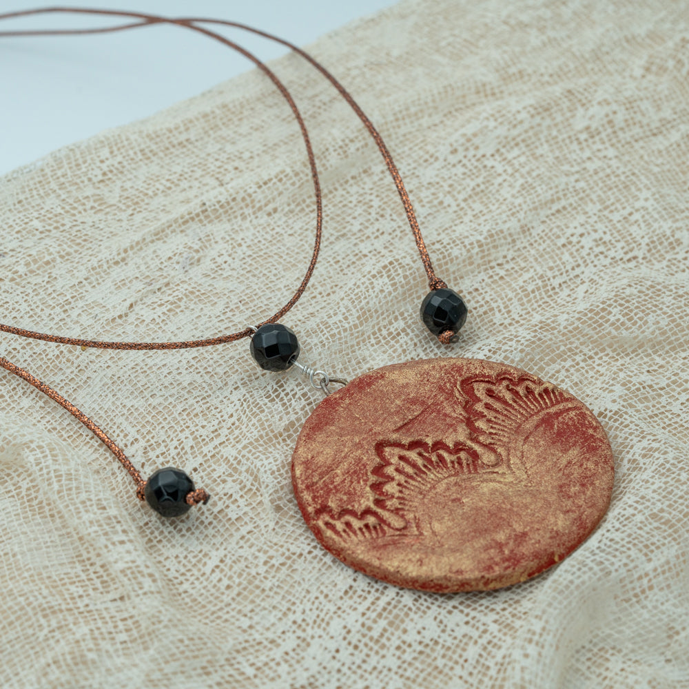 Handmade red-gold clay pendant