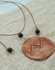 Handmade red-gold clay pendant