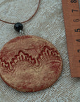 Handmade red-gold clay pendant