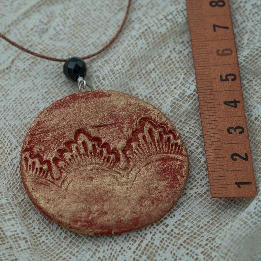 Handmade red-gold clay pendant