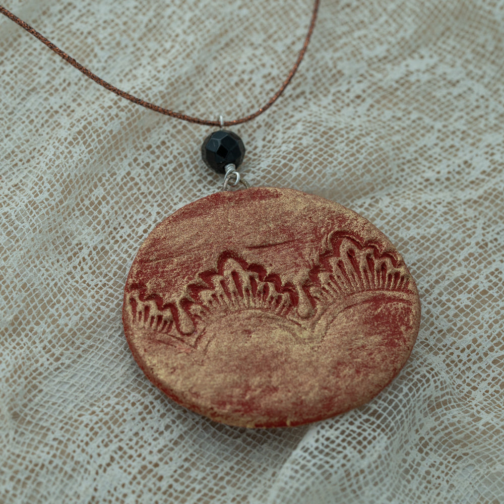 Handmade red-gold clay pendant