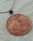 Handmade red-gold clay pendant