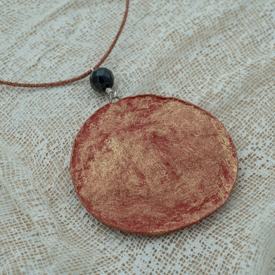 Handmade red-gold clay pendant