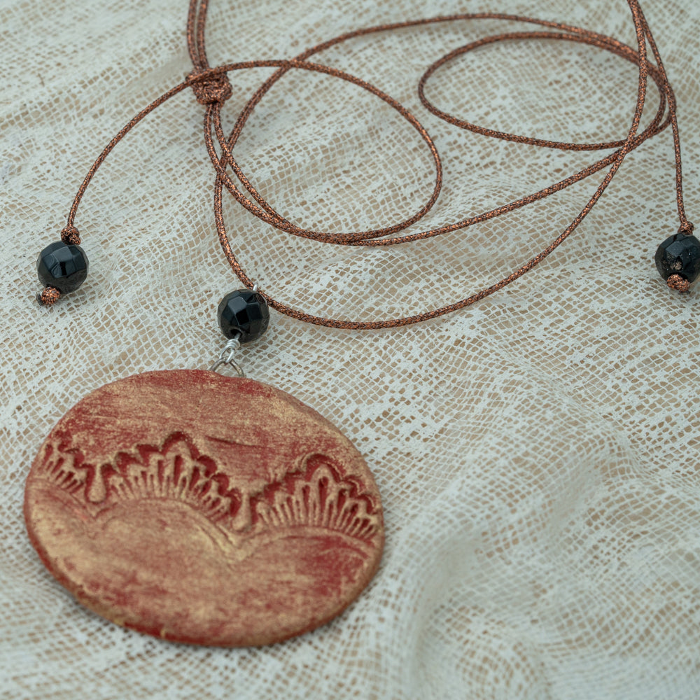 Handmade red-gold clay pendant