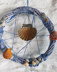 decorative wreath with seashells and pebbles