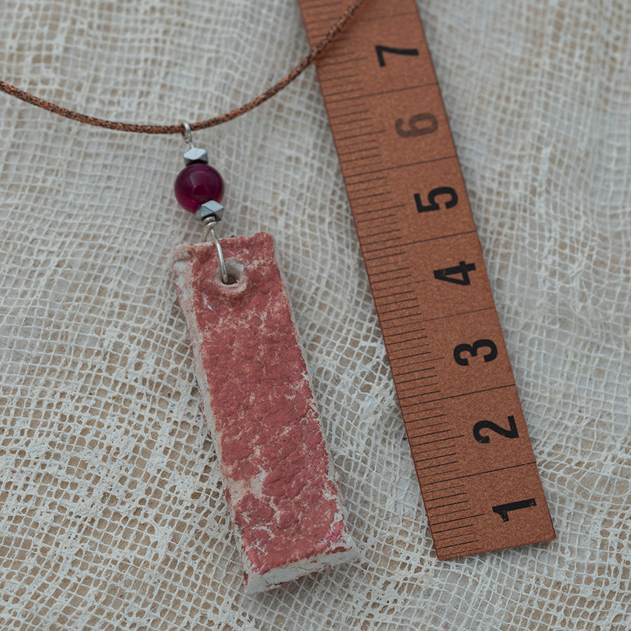 Clay pendant in red iridescent shades