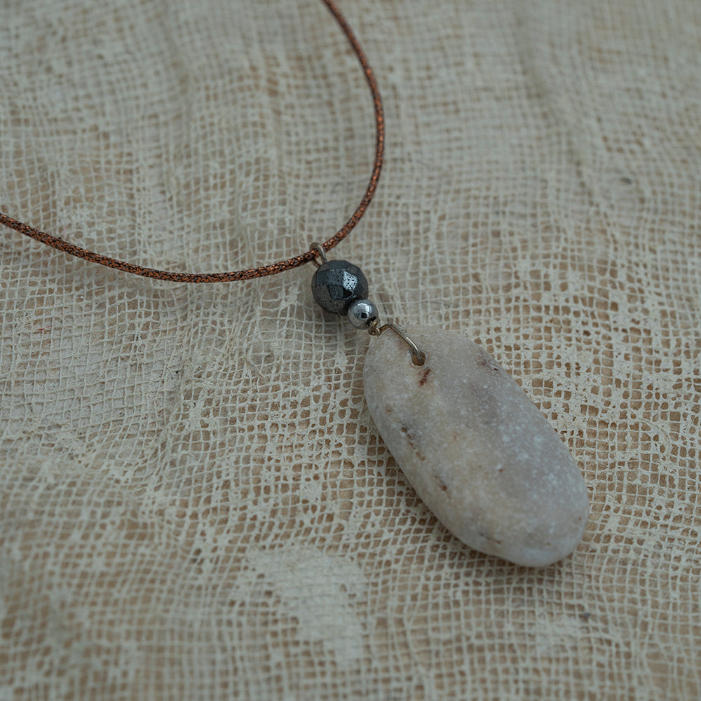 Sea pebble pendant with hematite