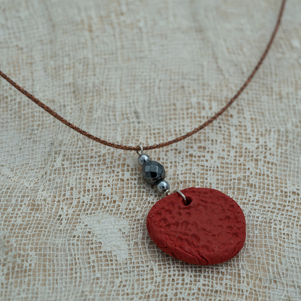 Handmade red clay pendant with hematite