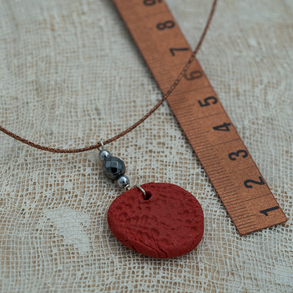 Handmade red clay pendant with hematite