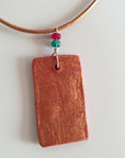 red gold clay pendant with agate