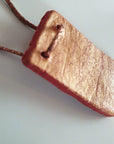 Handmade red-gold clay pendant